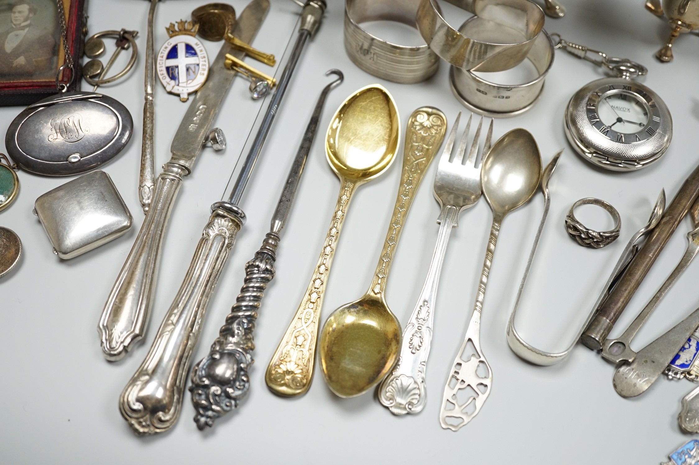 Sundry small silver including two sauceboats, napkin rings, mounted glass condiment bottle, pepperette, pair of silver gilt preserve spoons, minor flatware including white metal, a 1920's Georg Jensen silver cream ladle,